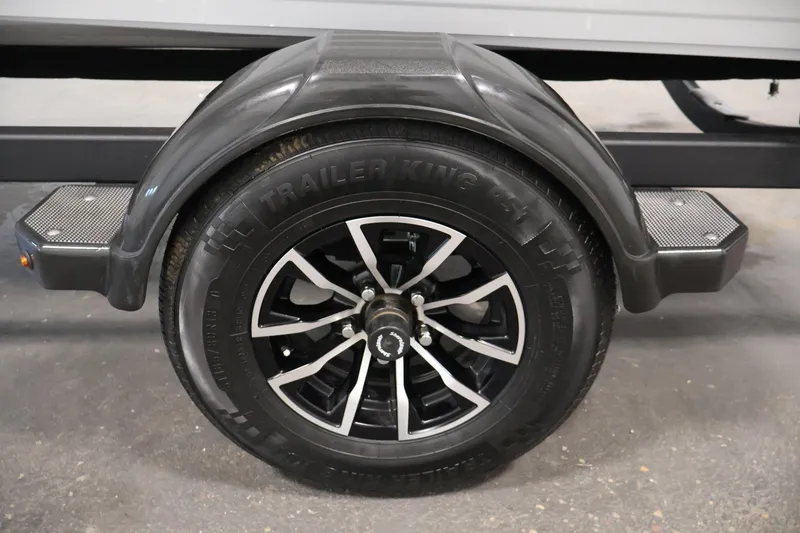 Slide: The Image of Trailer wheel of 2026 Crestliner 1650 Kodiak SC, featuring black alloy rim and fender. - 45