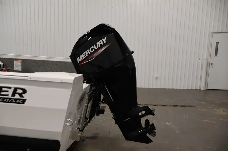 Slide: The Image of 2026 Crestliner 1650 Kodiak SC boat with Mercury outboard motor in a garage. - 39