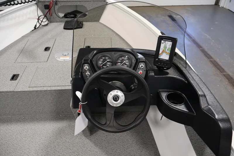 Slide: The Image of 2026 Crestliner 1650 Kodiak SC boat dashboard with steering wheel and navigation system. - 24