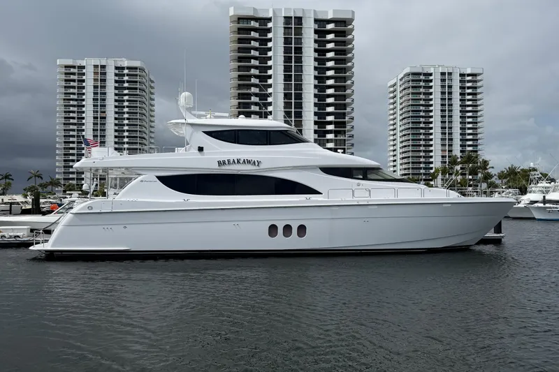 The Image of 2012 Hatteras 80 Motor Yacht docked near high-rise buildings. - 1