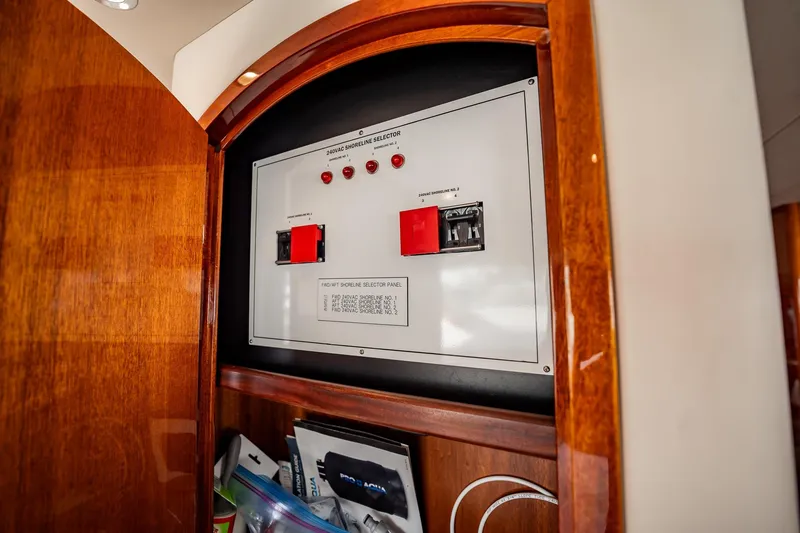 Slide: The Image of Electrical panel inside 2012 Hatteras 80 Motor Yacht, featuring shoreline selector switches. - 100