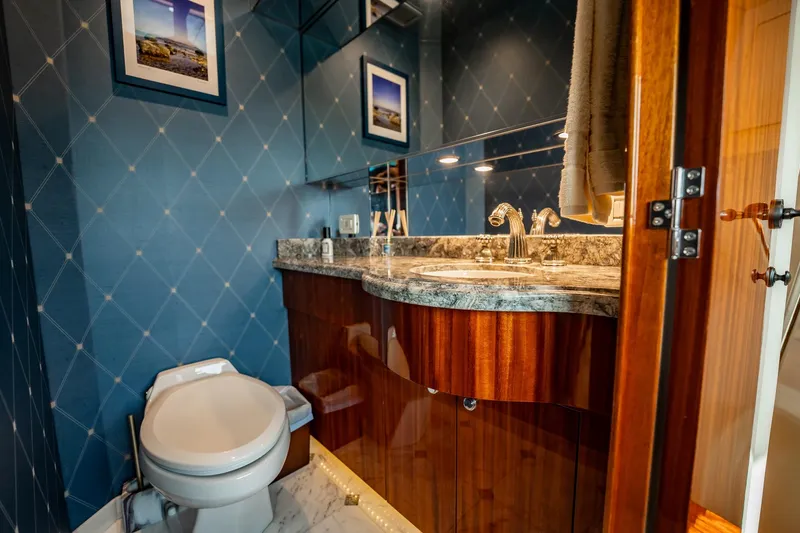 Slide: The Image of Luxurious bathroom on 2012 Hatteras 80 Motor Yacht with elegant wood cabinetry and marble countertop. - 102