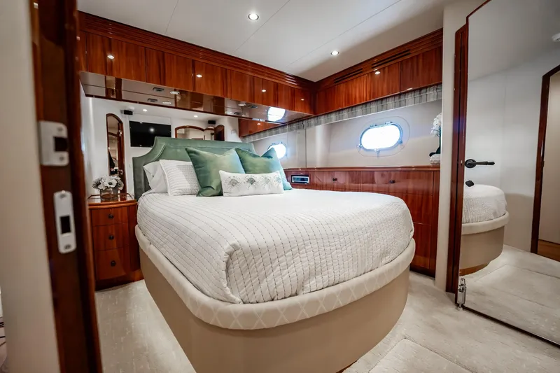 Slide: The Image of Luxurious bedroom interior of 2012 Hatteras 80 Motor Yacht with elegant wood finishes. - 108