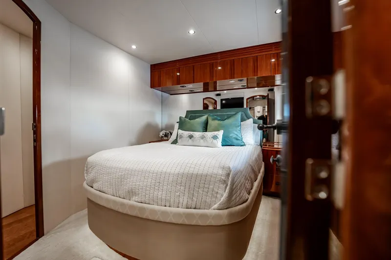 Slide: The Image of Luxurious bedroom interior of 2012 Hatteras 80 Motor Yacht with elegant bedding and wood accents. - 111