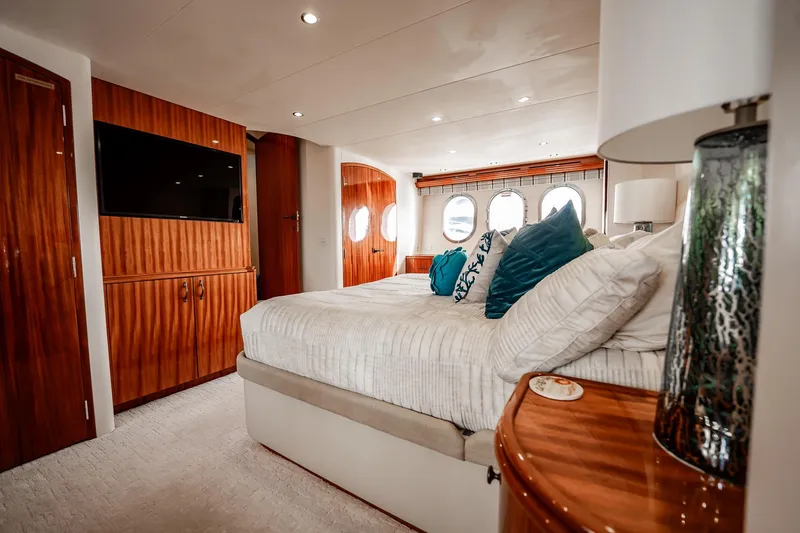 Slide: The Image of Luxurious bedroom interior of 2012 Hatteras 80 Motor Yacht with elegant wood finishes. - 112