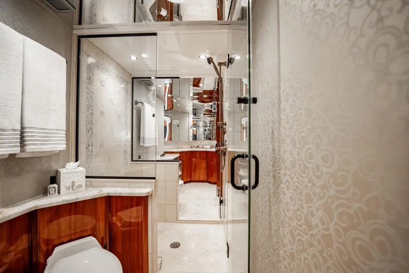Slide: The Image of Luxurious bathroom interior of 2012 Hatteras 80 Motor Yacht with elegant wood and glass accents. - 115