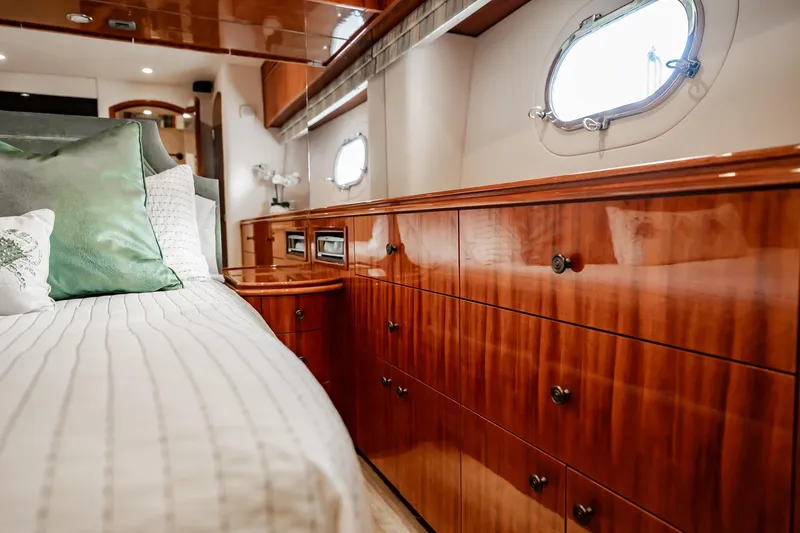Slide: The Image of Luxurious 2012 Hatteras 80 Motor Yacht bedroom with elegant wood cabinetry and plush bedding. - 116