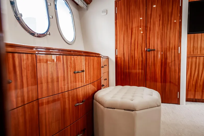 Slide: The Image of Luxurious interior of 2012 Hatteras 80 Motor Yacht with polished wood and plush seating. - 117