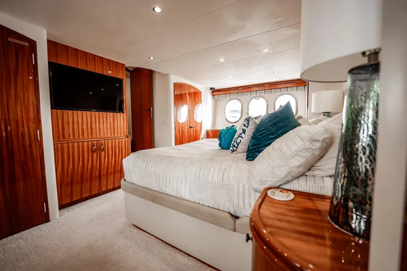 Slide: The Image of Luxurious bedroom interior of 2012 Hatteras 80 Motor Yacht with elegant wood finishes. - 119