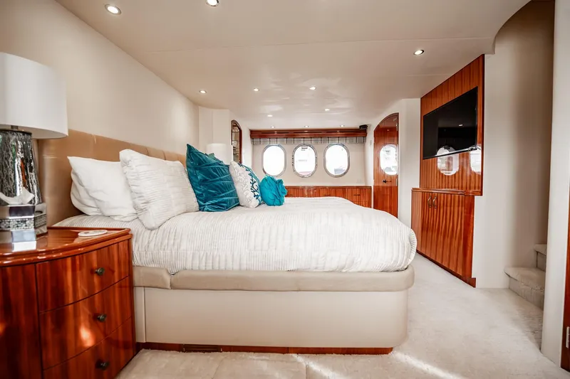 Slide: The Image of Luxurious bedroom interior of 2012 Hatteras 80 Motor Yacht with elegant wood finishes. - 121