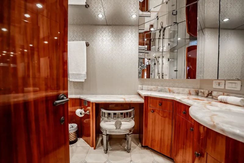 Slide: The Image of Luxurious bathroom on 2012 Hatteras 80 Motor Yacht with elegant wood cabinetry and marble countertops. - 122