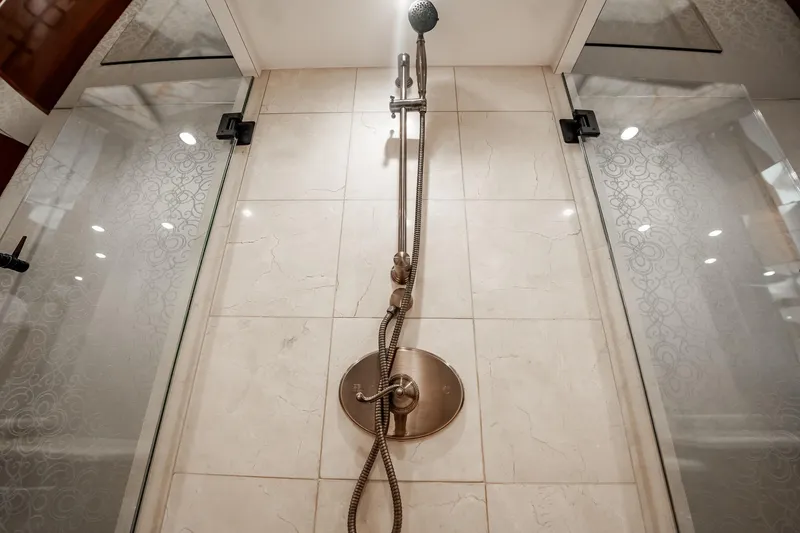 Slide: The Image of Luxurious shower in 2012 Hatteras 80 Motor Yacht with elegant glass doors and modern fixtures. - 123