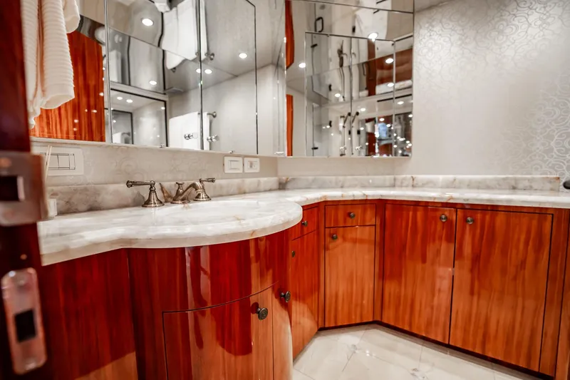 Slide: The Image of Luxurious bathroom with wooden cabinetry and marble countertop on 2012 Hatteras 80 Motor Yacht. - 127