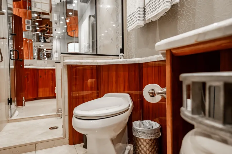 Slide: The Image of Luxurious bathroom interior on 2012 Hatteras 80 Motor Yacht, featuring elegant wood finishes. - 128