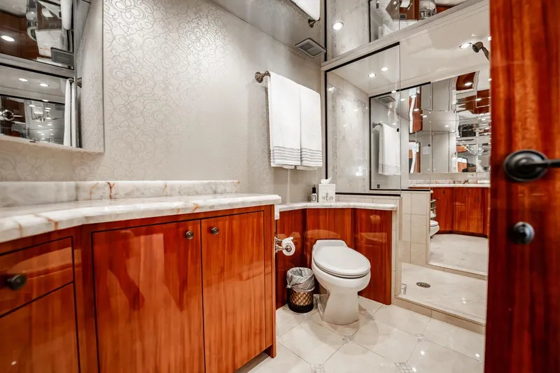 Slide: The Image of Luxurious bathroom in 2012 Hatteras 80 Motor Yacht with elegant wood cabinetry and marble countertops. - 129