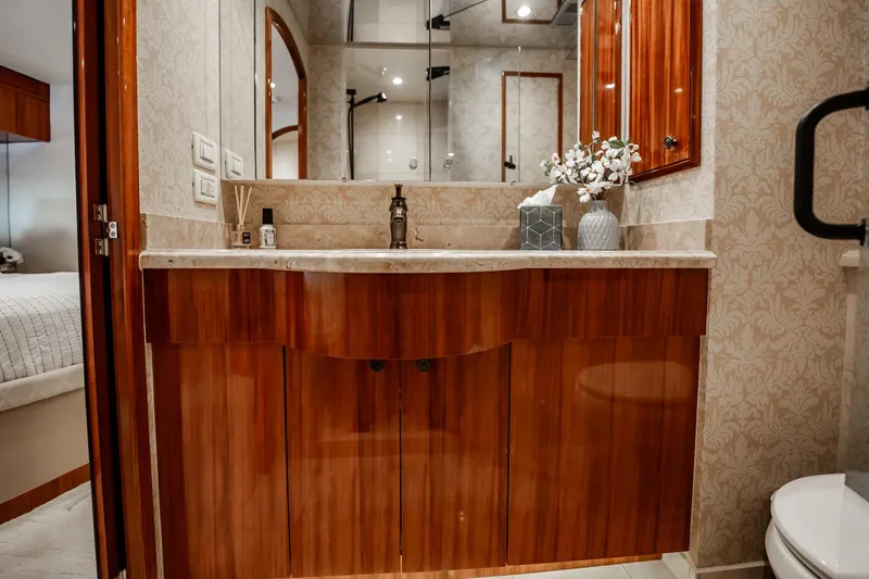 Slide: The Image of Luxurious bathroom interior on a 2012 Hatteras 80 Motor Yacht with elegant wood cabinetry. - 132