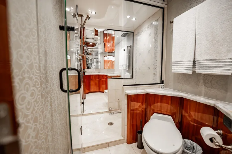 Slide: The Image of Luxurious bathroom in a 2012 Hatteras 80 Motor Yacht with elegant wood accents. - 133