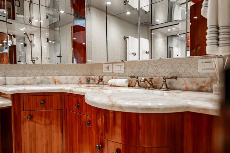 Slide: The Image of Luxurious bathroom vanity on 2012 Hatteras 80 Motor Yacht with marble countertop and elegant fixtures. - 135