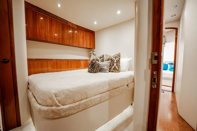 Slide: The Image of Luxurious bedroom interior on 2012 Hatteras 80 Motor Yacht with elegant wood finishes. - 145