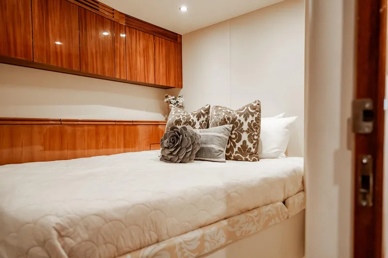Slide: The Image of Luxurious bedroom interior on 2012 Hatteras 80 Motor Yacht with elegant wood cabinetry. - 146