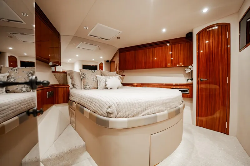 Slide: The Image of Luxurious bedroom interior of 2012 Hatteras 80 Motor Yacht with elegant wood finishes. - 150