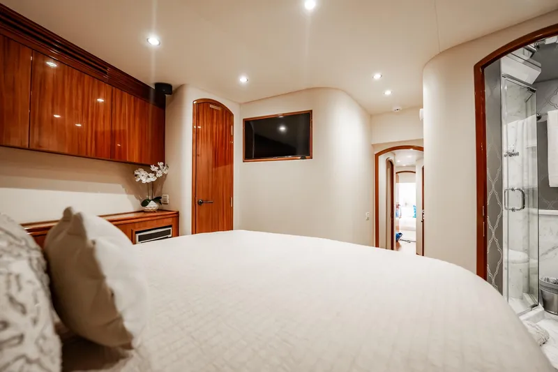 Slide: The Image of Luxurious bedroom interior of 2012 Hatteras 80 Motor Yacht with elegant wood finishes. - 152