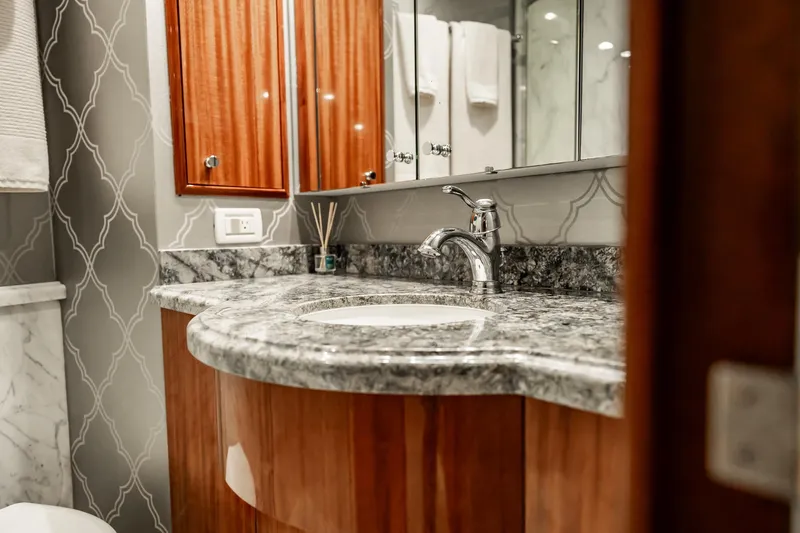 Slide: The Image of Luxurious bathroom on 2012 Hatteras 80 Motor Yacht with marble countertop and elegant fixtures. - 155