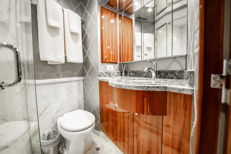 Slide: The Image of Luxurious bathroom in 2012 Hatteras 80 Motor Yacht with elegant wood cabinetry and marble accents. - 156
