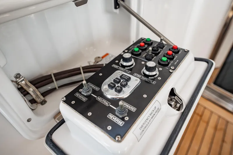 Slide: The Image of Control panel of a 2012 Hatteras 80 Motor Yacht, featuring throttle and navigation controls. - 157