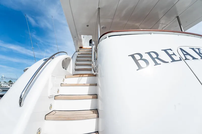 Slide: The Image of Staircase on 2012 Hatteras 80 Motor Yacht under clear blue sky. - 159