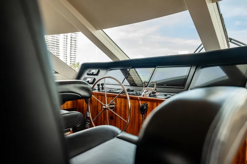 Slide: The Image of Helm of 2012 Hatteras 80 Motor Yacht with modern controls and steering wheel. - 16
