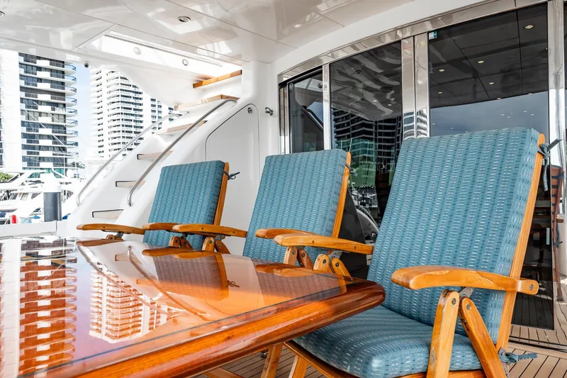 Slide: The Image of Luxury deck seating on 2012 Hatteras 80 Motor Yacht with cityscape view. - 160