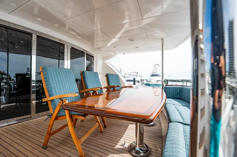 Slide: The Image of Luxurious deck of 2012 Hatteras 80 Motor Yacht with elegant seating and table. - 161