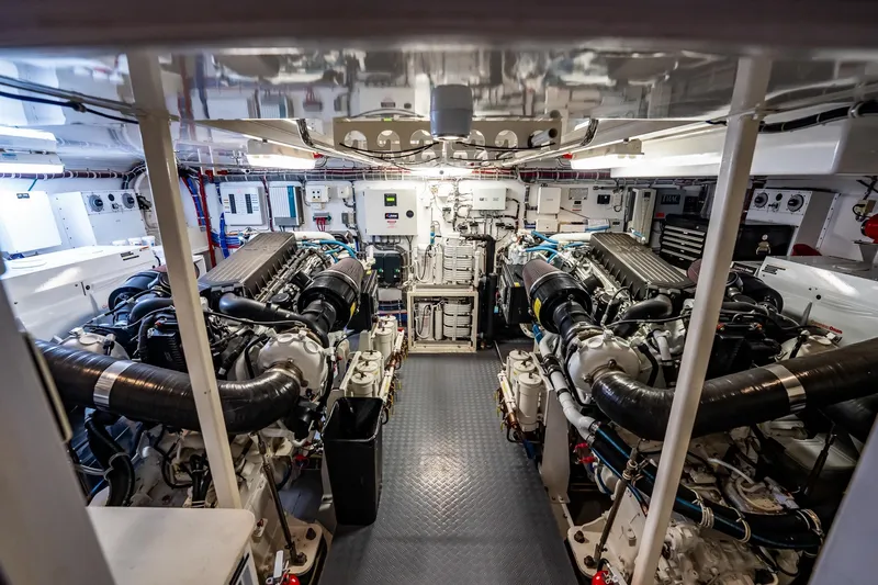 Slide: The Image of Engine room of a 2012 Hatteras 80 Motor Yacht, showcasing dual engines and technical equipment. - 169