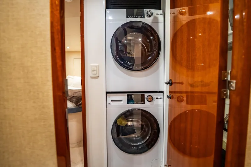 Slide: The Image of Stacked washer and dryer in 2012 Hatteras 80 Motor Yacht laundry area. - 171