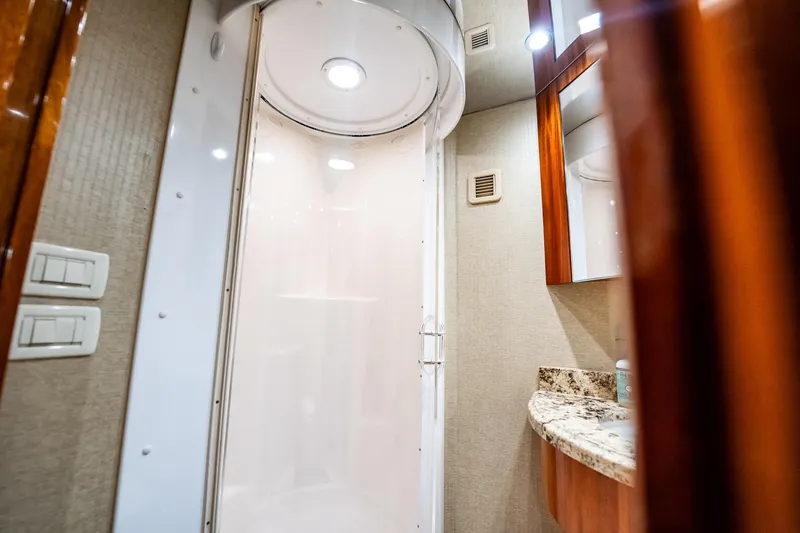 Slide: The Image of Luxurious bathroom interior of 2012 Hatteras 80 Motor Yacht with modern shower and granite countertop. - 179