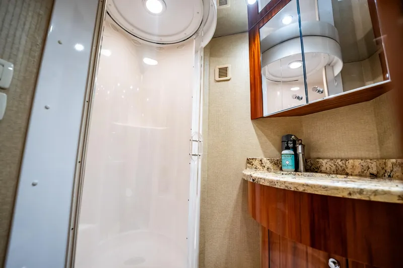 Slide: The Image of Luxurious bathroom interior of 2012 Hatteras 80 Motor Yacht with modern shower and granite countertop. - 181