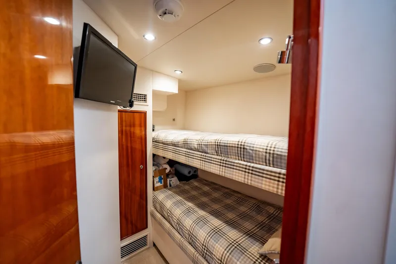 Slide: The Image of Interior of 2012 Hatteras 80 Motor Yacht with bunk beds and wall-mounted TV. - 182