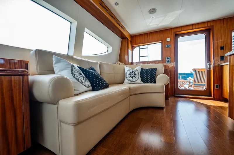 Slide: The Image of Luxurious interior of 2012 Hatteras 80 Motor Yacht with elegant seating and wooden accents. - 21