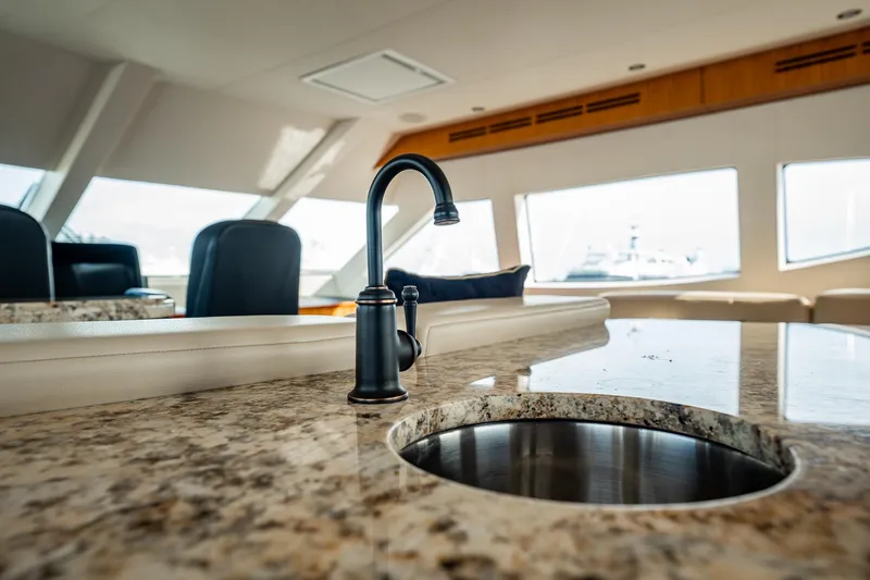 Slide: The Image of Luxurious interior of 2012 Hatteras 80 Motor Yacht with granite countertop and modern faucet. - 22