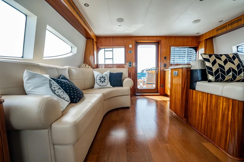 Slide: The Image of Luxurious interior of 2012 Hatteras 80 Motor Yacht with elegant seating and wooden accents. - 23