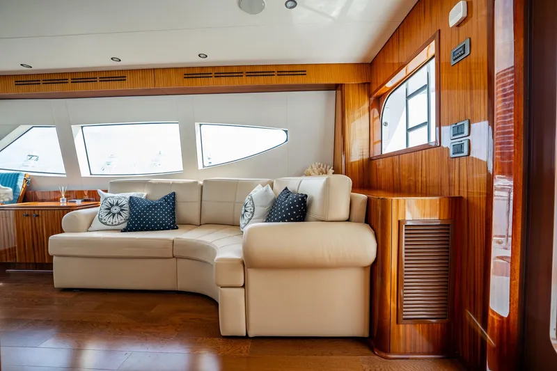 Slide: The Image of Luxurious interior of 2012 Hatteras 80 Motor Yacht with elegant seating and wood finishes. - 25