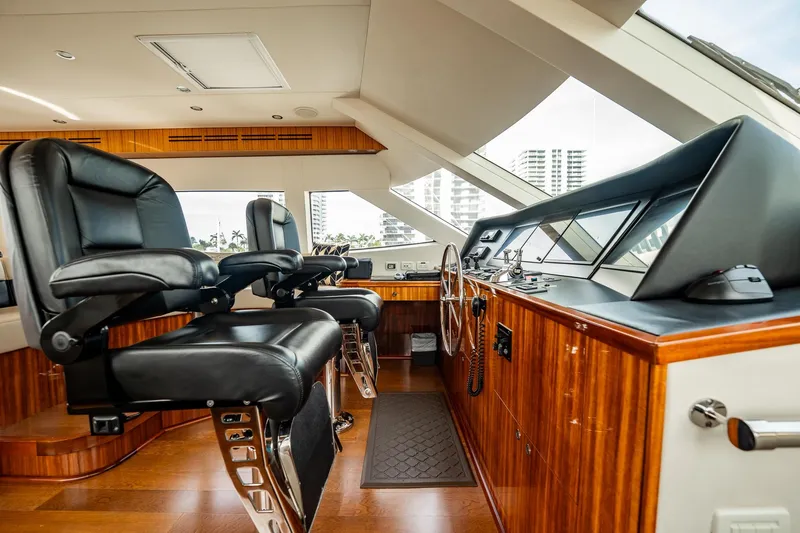 Slide: The Image of Luxurious helm of 2012 Hatteras 80 Motor Yacht with leather seating and wood finish. - 26