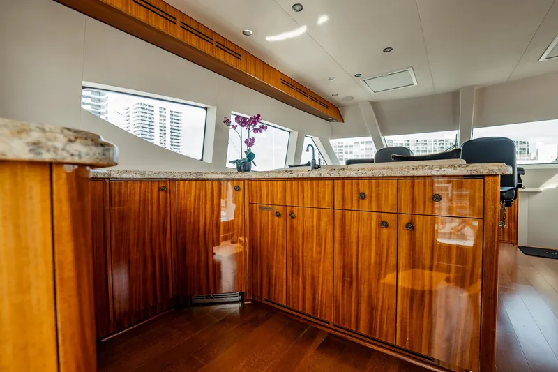 Slide: The Image of Luxurious interior of 2012 Hatteras 80 Motor Yacht with elegant wood cabinetry and granite countertops. - 28