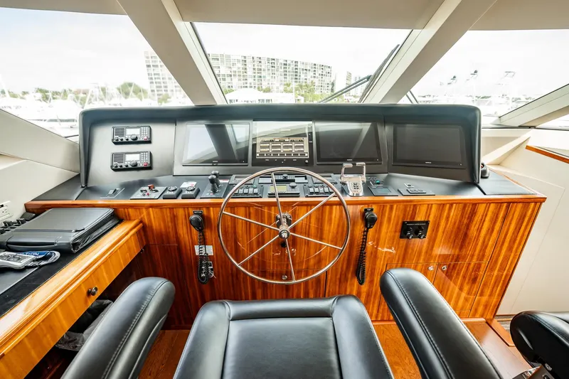Slide: The Image of Helm of 2012 Hatteras 80 Motor Yacht with modern navigation equipment and wooden finish. - 29
