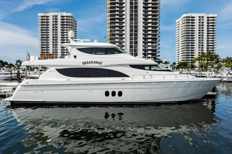 Slide: The Image of 2012 Hatteras 80 Motor Yacht docked with skyscrapers in the background. - 3