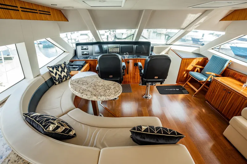 Slide: The Image of Luxurious interior of 2012 Hatteras 80 Motor Yacht with elegant seating and helm station. - 31