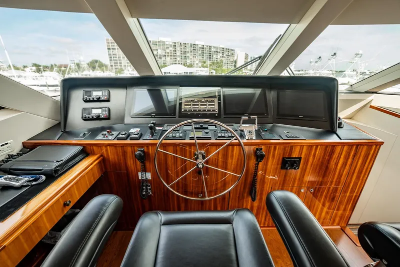 Slide: The Image of Helm of 2012 Hatteras 80 Motor Yacht with modern navigation equipment and luxurious wood finish. - 34