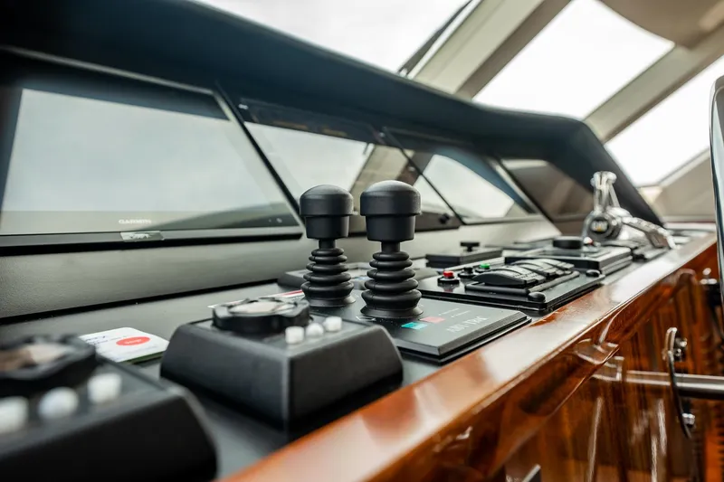 Slide: The Image of Control panel of 2012 Hatteras 80 Motor Yacht with navigation screens and joysticks. - 35