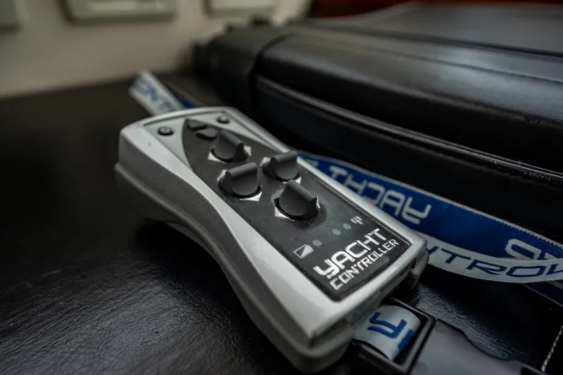 Slide: The Image of Remote control for 2012 Hatteras 80 Motor Yacht, featuring multiple buttons and lanyard. - 36